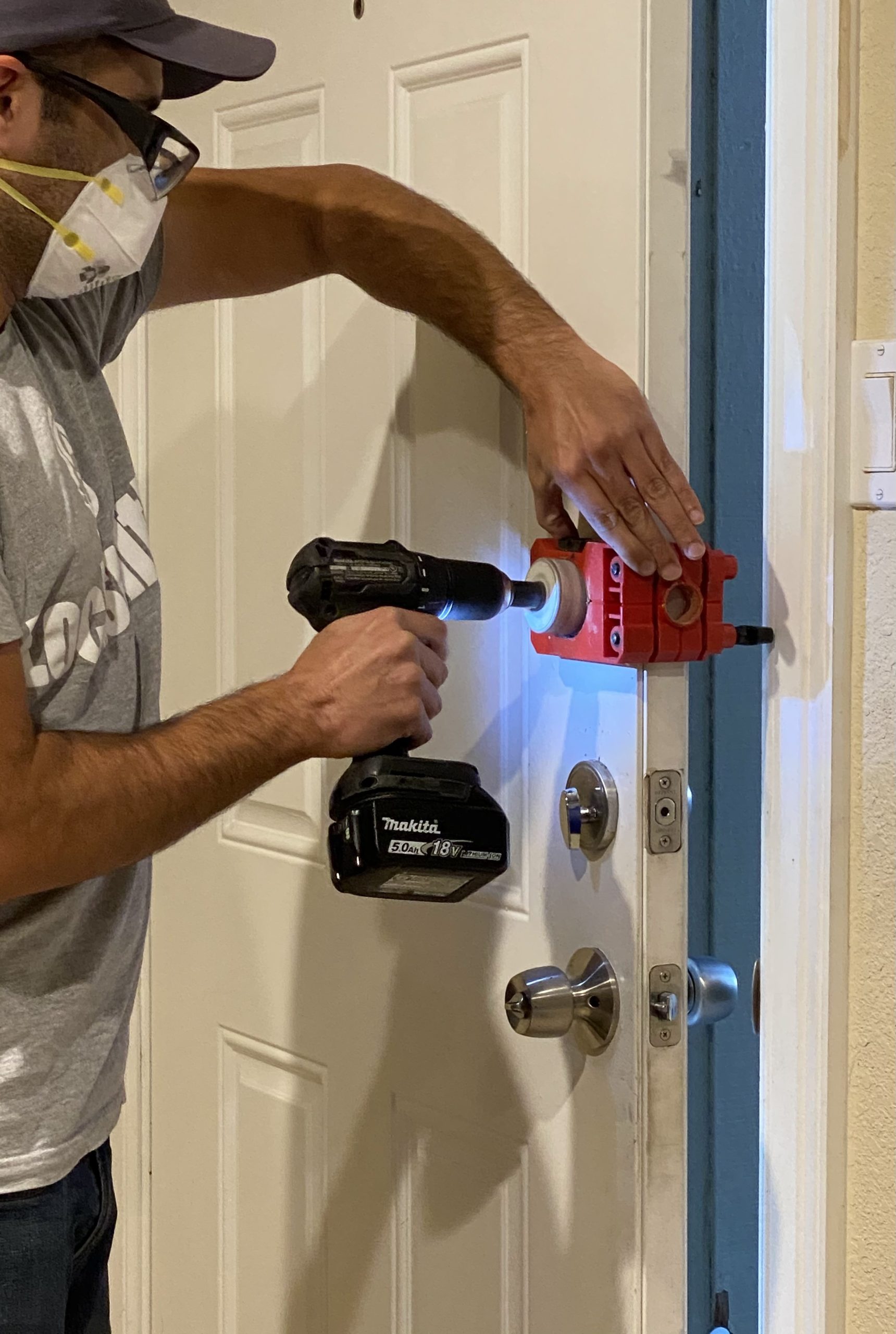 Residential_Locksmith-3 man fixing lock on door